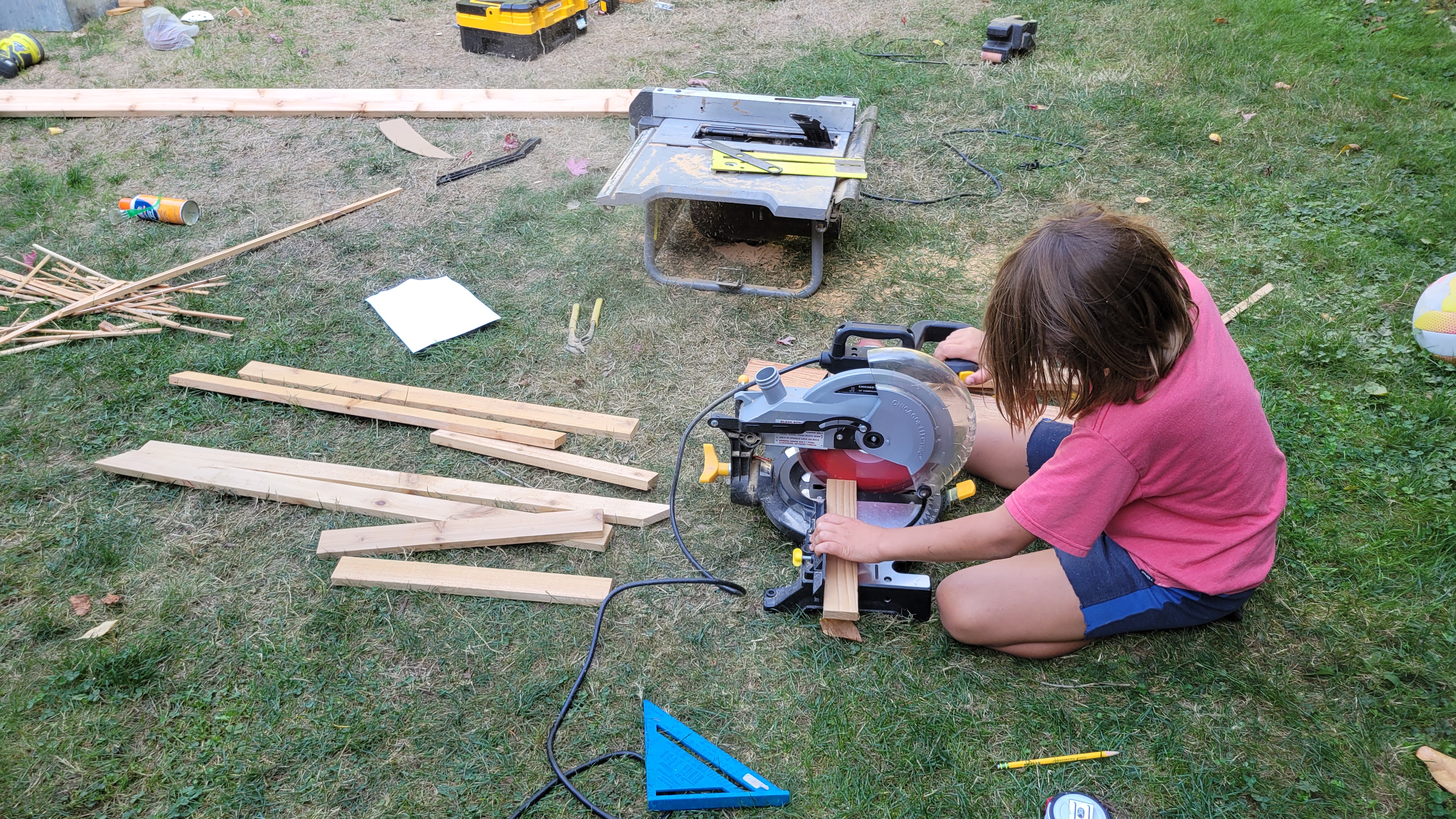 Tim at work in the workshop, cutting wood with a miter saw